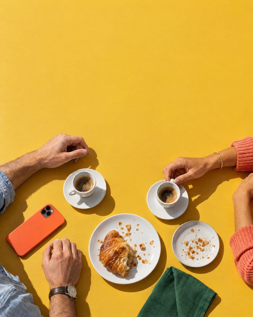 Coffee and a croissant for two on a yellow table